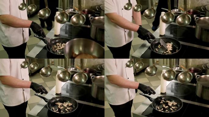 厨师在餐厅厨房的煎锅中煎炸鸡肉的特写镜头