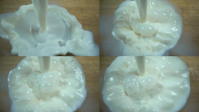牛奶以慢动作倒入透明的碗中。