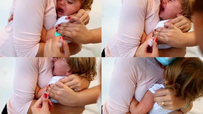 给幼儿接种疫苗。父母抱着婴儿进行疫苗接种