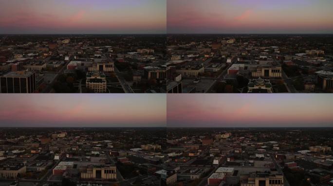 在宁静的一天里，美丽的清晨空中飞过托莱多市中心北部的市中心和商业区，天空变成了粉色和蓝色，两辆警车闪