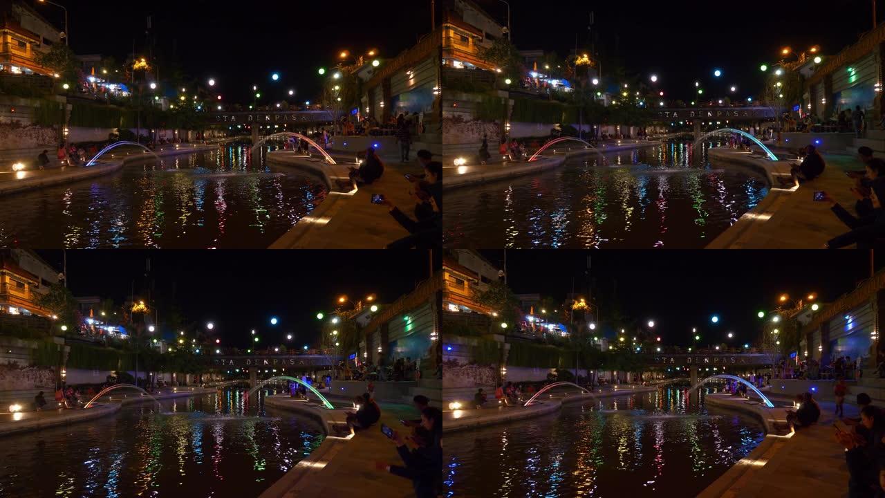 巴厘岛夜间时间著名的登巴萨市河畔拥挤的海滨长廊湾全景4k印度尼西亚