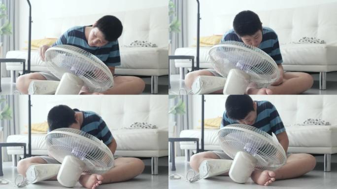 亚洲男孩在家学习如何组装电风扇，生活方式理念。