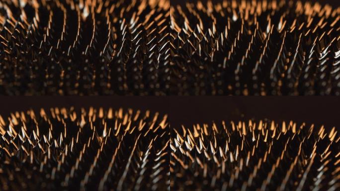 在钕磁铁的作用下，铁磁流体物质上的磁性和橙色光可以产生令人印象深刻的视觉效果。VJ，科幻小说和抽象艺