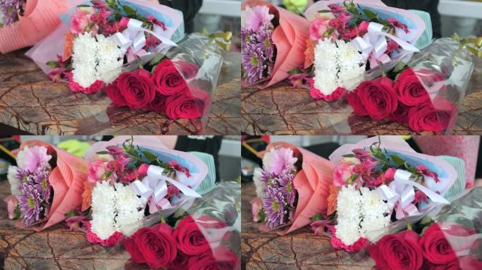 女售货员把漂亮的新鲜花束放在大理石桌子特写上
