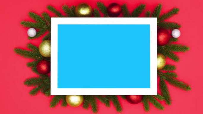 带有装饰品的圣诞树枝出现在带有蓝屏的框架周围。停止运动