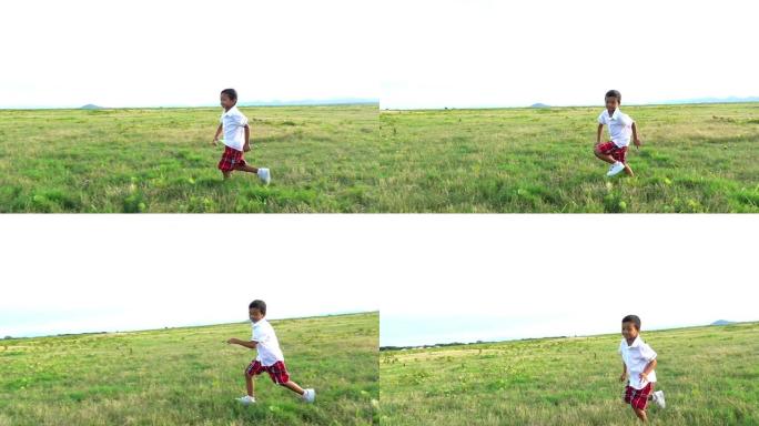 一个男孩用绿草慢动作奔跑。