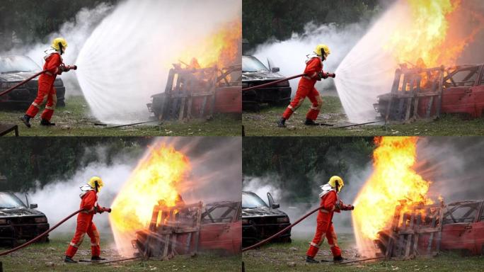 勇敢的消防员穿着消防服，负责安全救援工作，从消防水带喷洒水，扑灭爆炸燃烧汽车上的crack啪作响的火