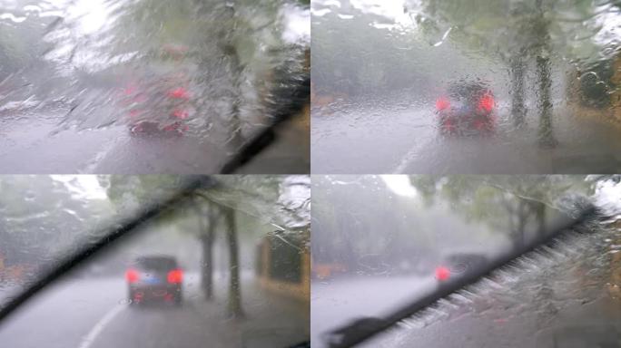 通过带有大雨的车窗观看道路交通，在雨中从汽车挡风玻璃观看交通，4k b滚动镜头，重点是降雨。
