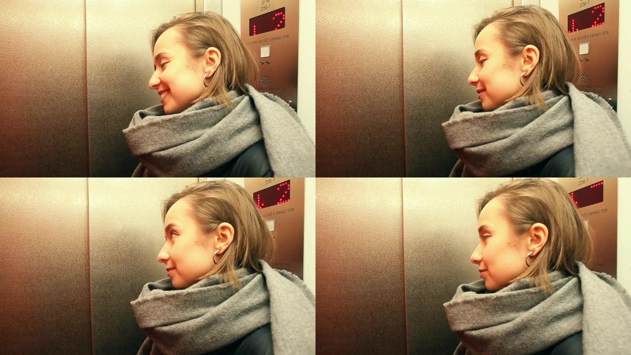 女人围巾坐电梯，等待出口。自动运送乘客水平。