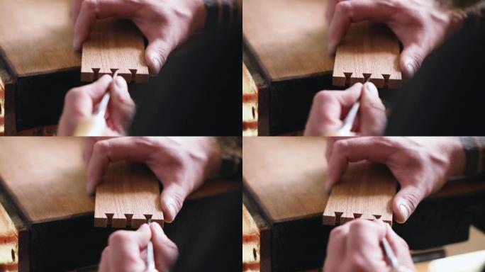 细木工用木凿将燕尾榫缝雕刻成橡木木板。木工、工艺、手工艺品。木工工具的声音