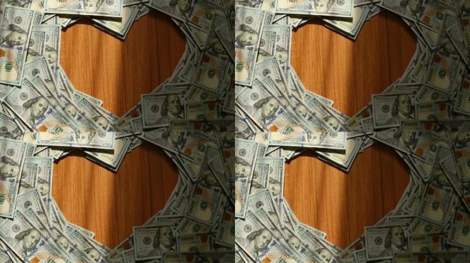 多莉拍摄: 心形边框，带有美国100美元纸币，中间有一个复制空间