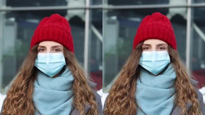 站在街上的白种人年轻卷发女性戴着医用口罩的纵向照片。大流行性流感电晕病毒。疫情冠状病毒。人群患病新型