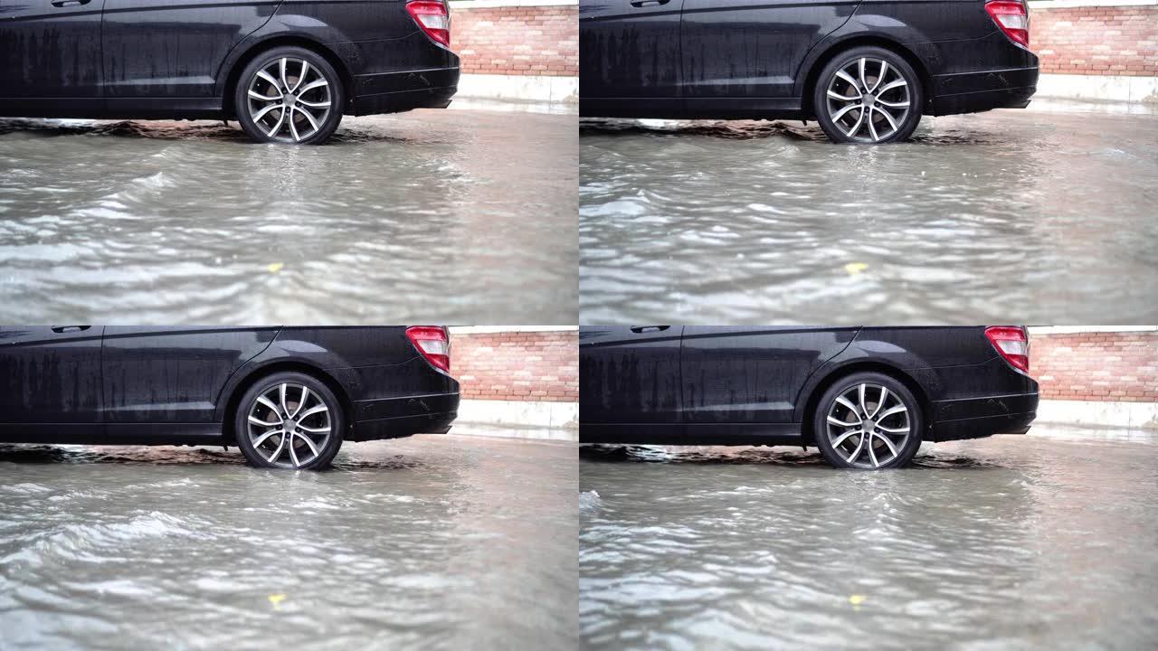 水淹没了现代黑色汽车的街道和停车场