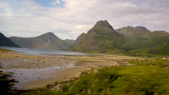 在挪威的罗弗滕群岛驾驶着巨大的山崖在挪威驾驶汽车