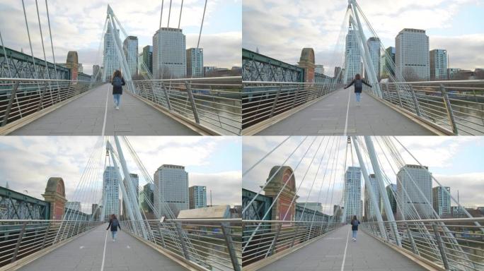 一个背着背包的女孩游客在伦敦千禧桥上奔跑，处于封锁状态。