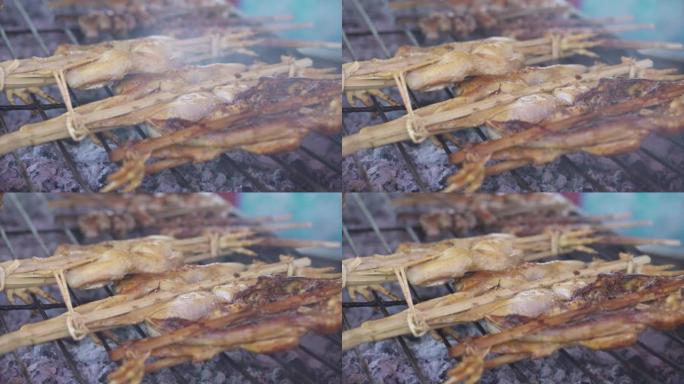 用竹子塞住的草药烧烤鸡肉，炉子上的鸡肉烤架，泰国的街头食品