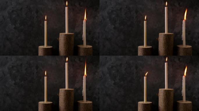 零浪费概念，棕色桌子上的天然木制树桩烛台。在黑暗背景上燃烧蜡烛。Spa健康放松，环保手工家居设计。无