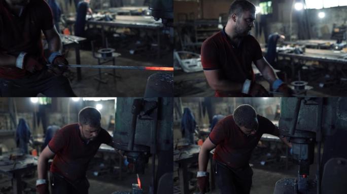 铁匠用铁匠的锤子锻造红色的热金属坯料