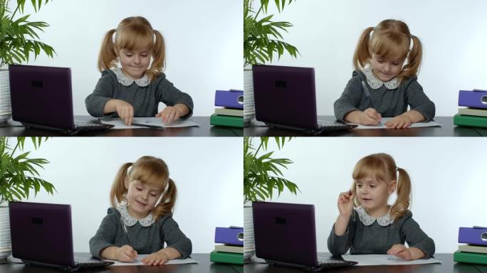 学龄前儿童女孩远程在线学习在家。使用数字笔记本电脑学习的孩子