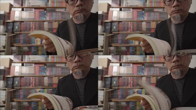 亚洲老年人戴眼镜在家里读小说