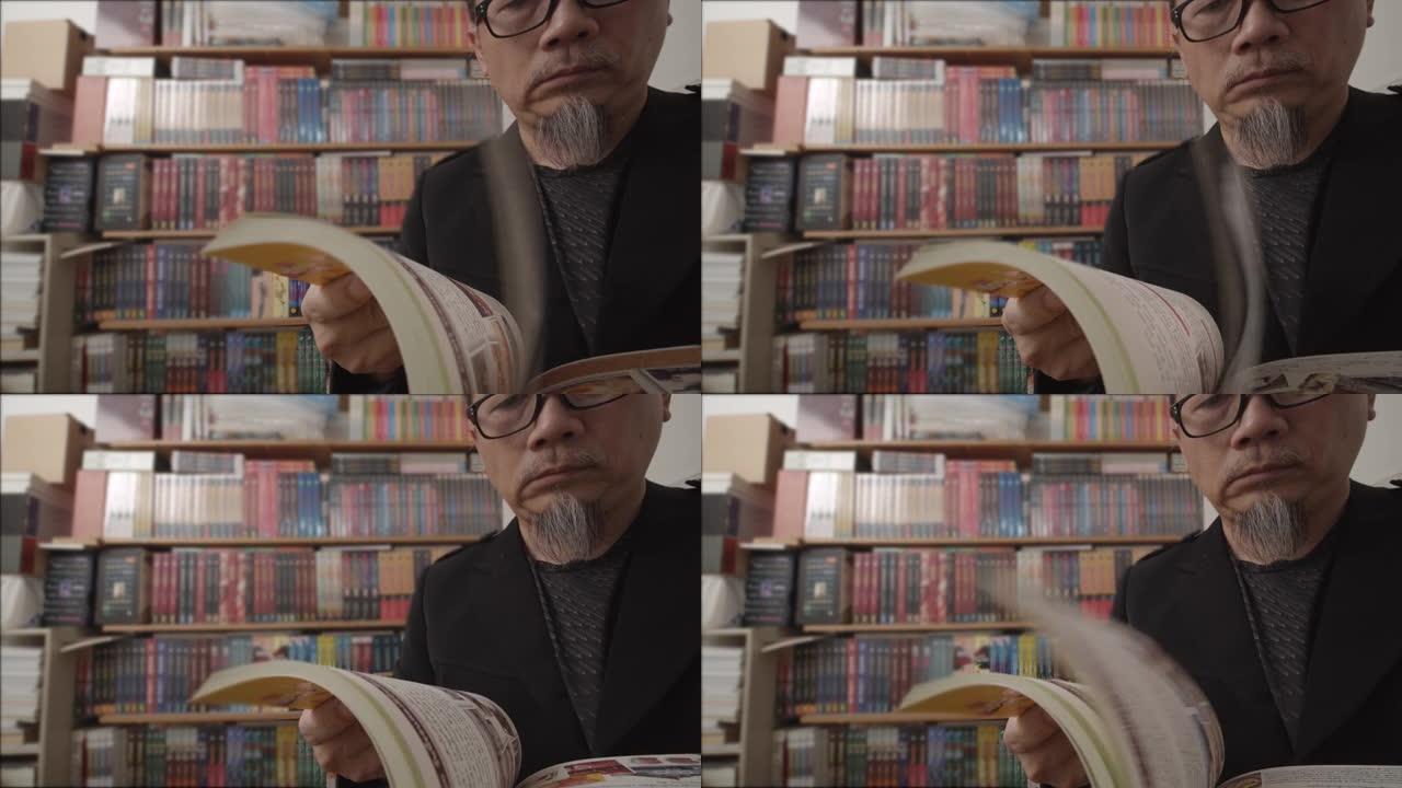 亚洲老年人戴眼镜在家里读小说