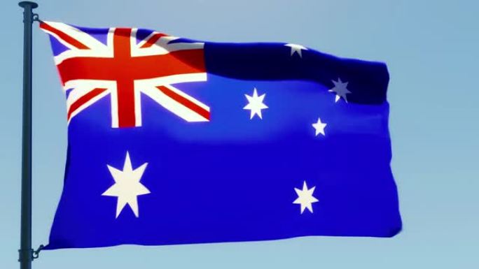 澳大利亚国旗在风中飘扬，映衬着朦胧的蓝天