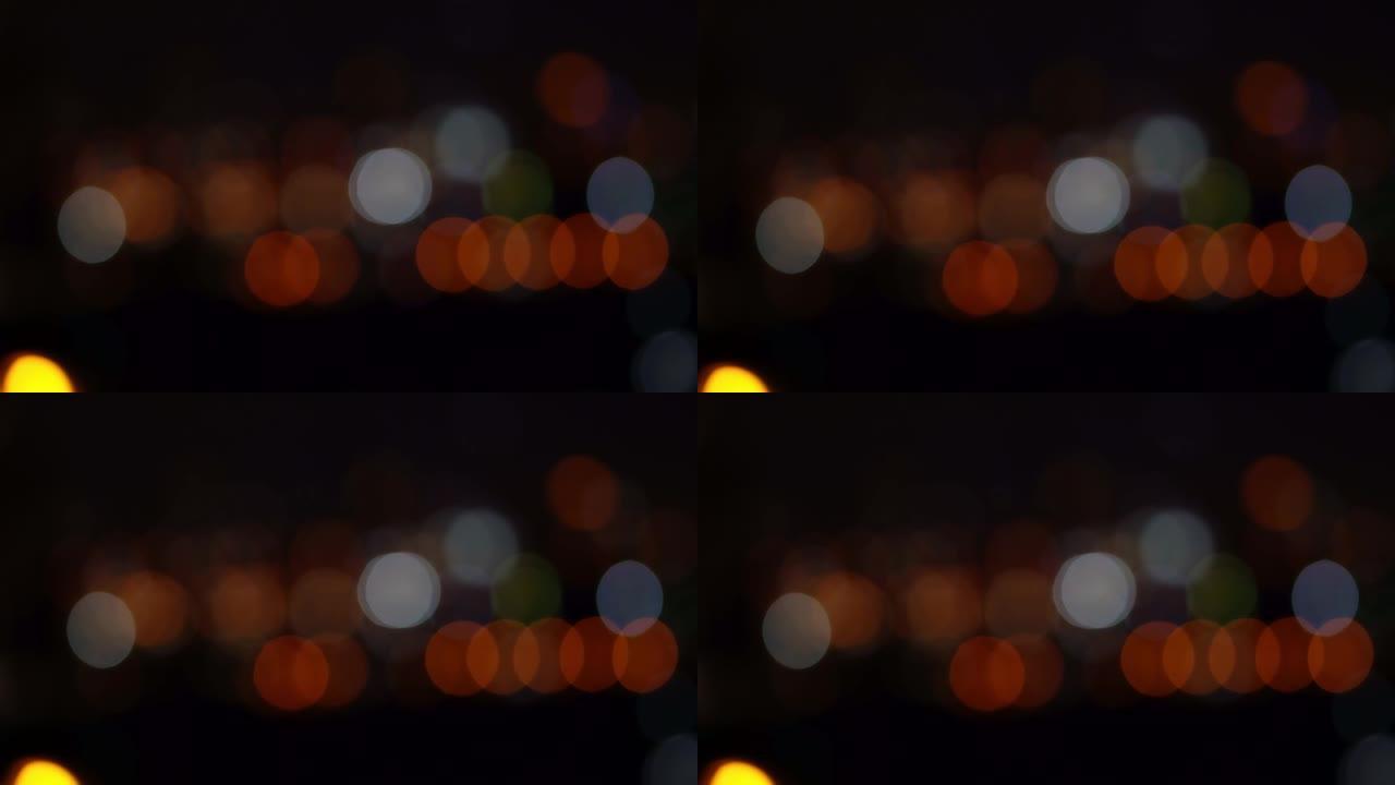 夜间黑暗模糊背景中的Bokeh，散焦的夜间交通信号灯，玻璃状的圆形形状