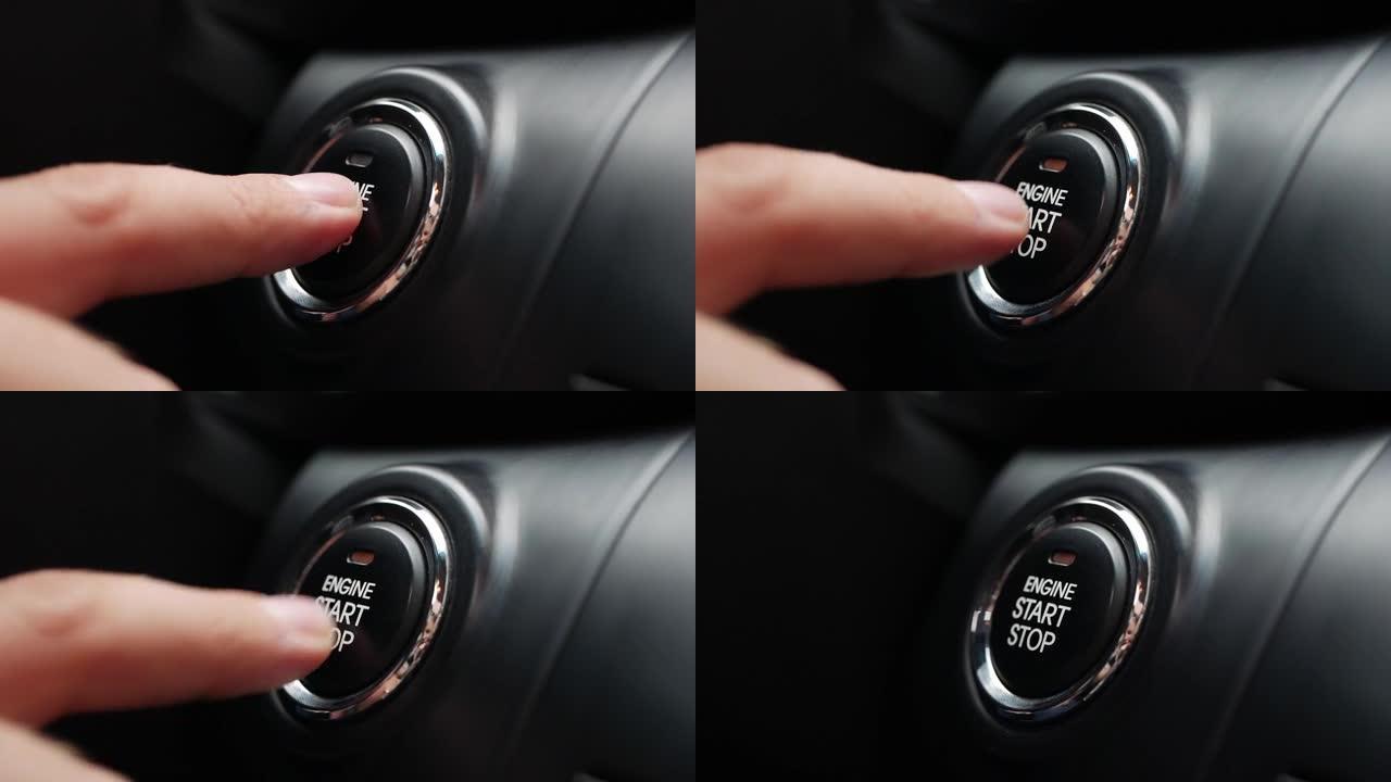 男子正在按下汽车发动机启动按钮。按下按钮启动汽车发动机。特写