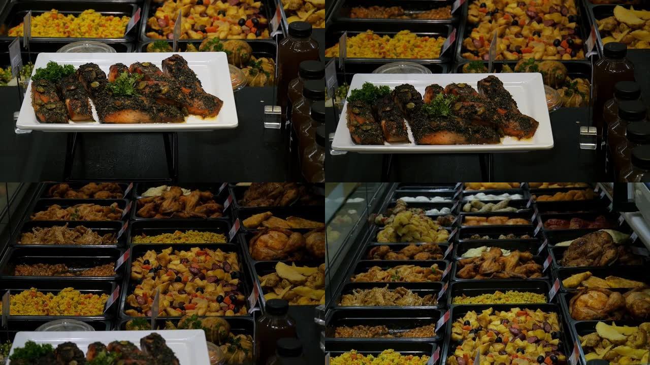 食物。超市里有很多食物。盘子上有红鱼和许多不同的沙拉。超市展示。4k拍摄