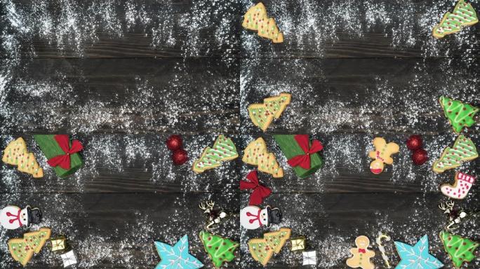 停止运动平躺视图: 白色糖霜如雪落下，装饰糖霜，自制圣诞饼干，如姜饼，圣诞树，圣诞老人，和礼物，装饰