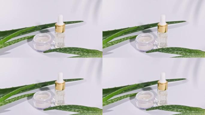 芦荟油，叶子在白色背景上。基于芦荟提取物的化妆品
