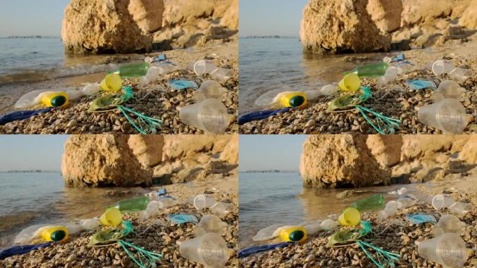 冲浪区海滩上的一次性口罩和塑料碎片。冠状病毒新型冠状病毒肺炎正在造成污染，因为废弃的二手口罩杂乱无章