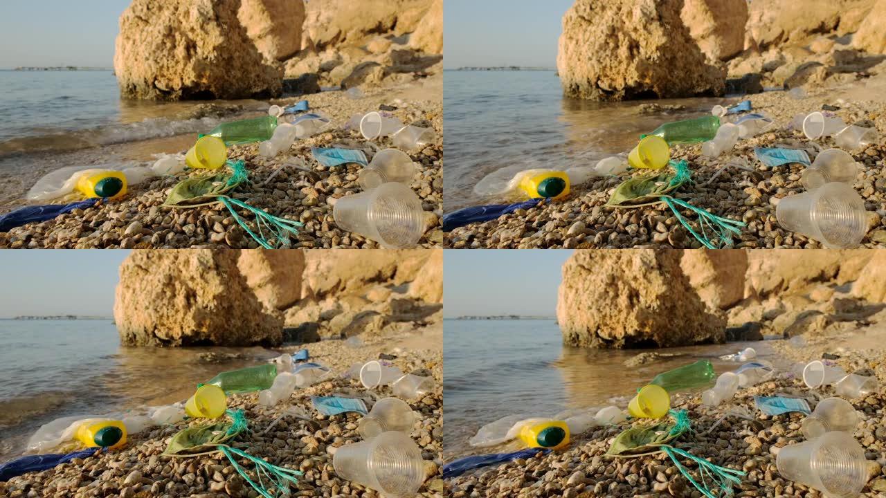冲浪区海滩上的一次性口罩和塑料碎片。冠状病毒新型冠状病毒肺炎正在造成污染，因为废弃的二手口罩杂乱无章
