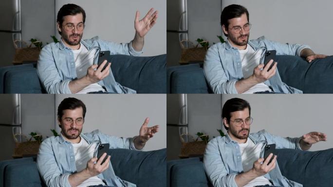 用智能手机与朋友进行在线通话时，一个戴着眼镜的男人微笑着的特写镜头