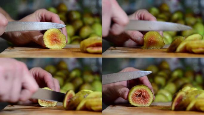 男性用刀在厨房切菜板上切新鲜采摘的无花果。健康食品。