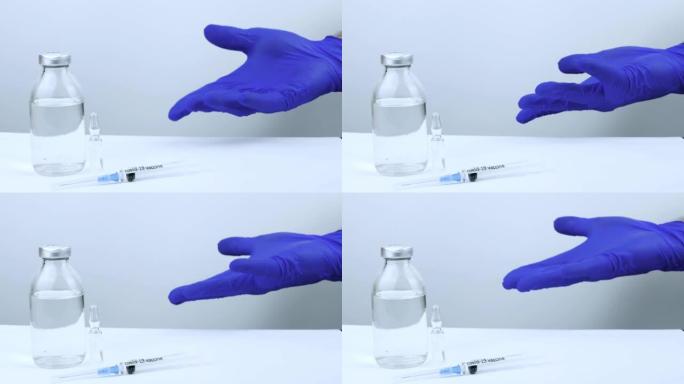 医生演示了针对新型冠状病毒肺炎的疫苗，挥舞着他的手，用疫苗将手指指向瓶子，close-up.The带