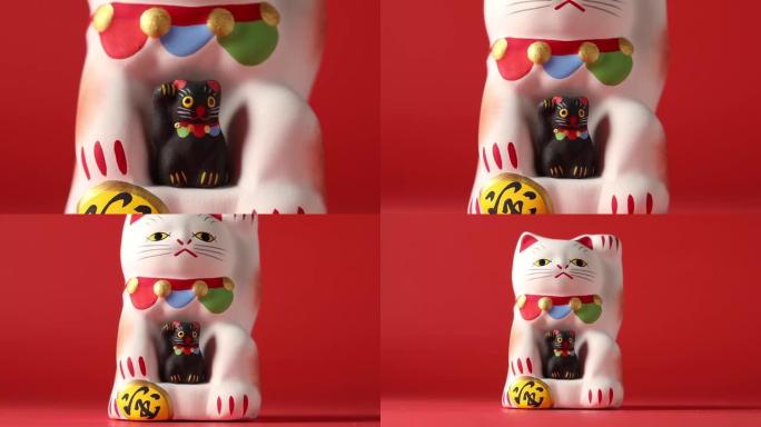 Maneki-neko，幸运的猫，有一只黑色的小猫特写