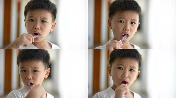亚洲孩子在浴室刷牙。日常健康和牙科护理的概念