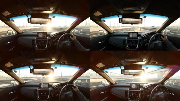 夫妇在公路旅行中，车辆视点驾驶到日落，驾驶员视点的宽图像视图