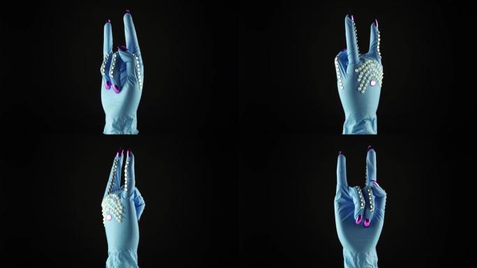 女人手腕手和岩石符号。交出蓝色医疗装饰手套PPE。一次性手术防护手套中的女性手掌。岩石概念与COVI