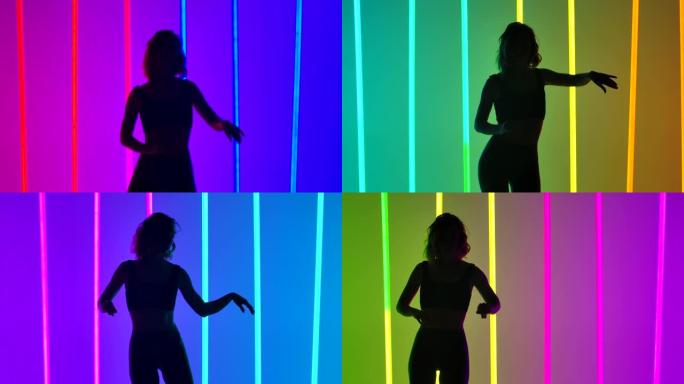 一个穿着紧身裤和上衣的苗条女人正在慢动作中练习莎莎舞动作。工作室中舞者的剪影在彩色霓虹灯的背景下。特