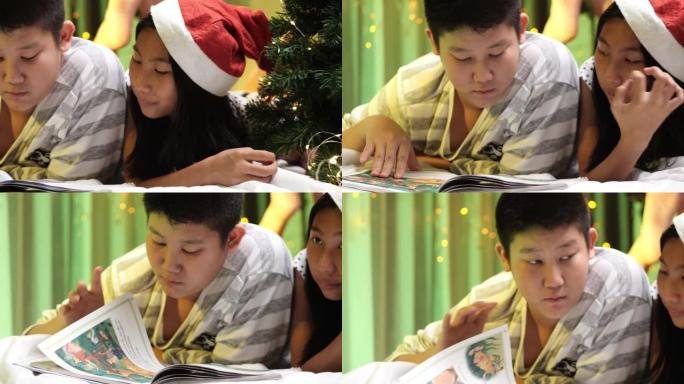 快乐的亚洲儿童看书，晚上躺在床上，带着圣诞装饰品，生活方式理念。