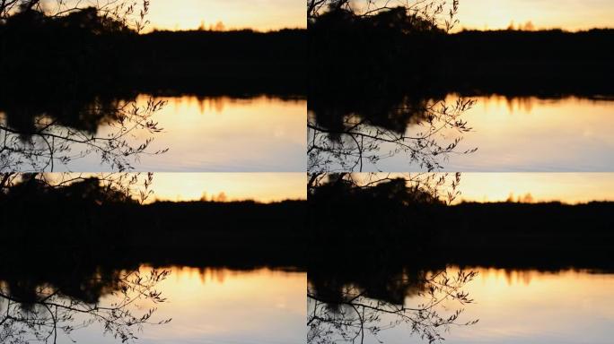 反射山湖上方风景秀丽的日落。日落时反射山湖。
