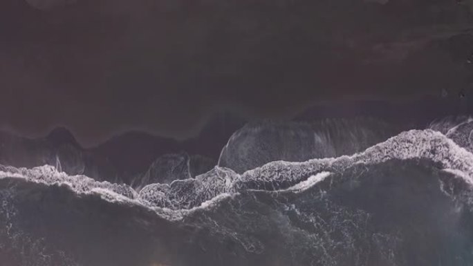 鸟瞰图。海浪冲向美丽的冰岛黑沙滩的惊人航拍画面