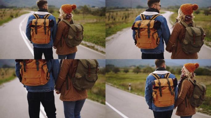 乡村路上的年轻徒步旅行者夫妇