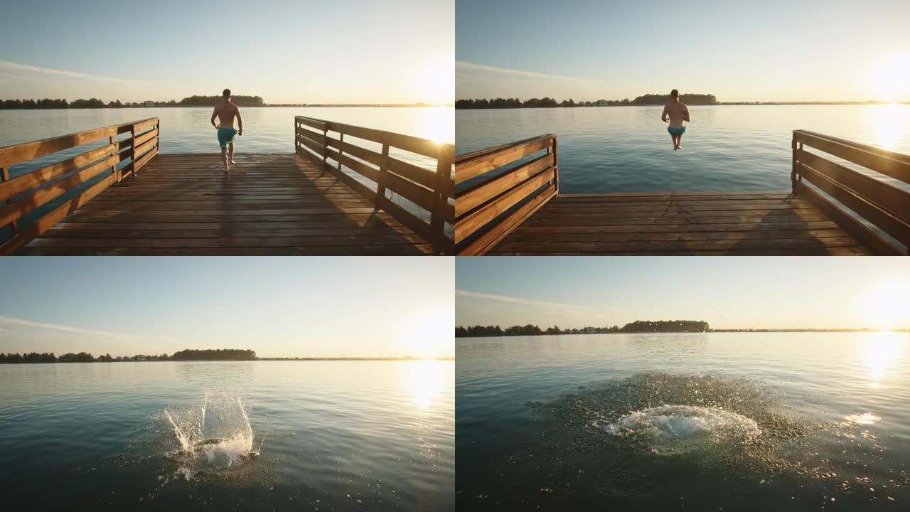 一个年轻人跑下码头，像炸弹一样跳进湖里。在湖上休息。日落。4 k