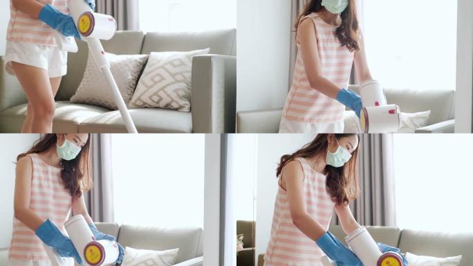 在家清洁口罩的女管家。女佣戴着防护面具和橡胶手套打扫房间。家庭清洁服务新型冠状病毒肺炎概念。