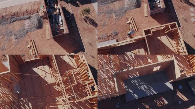 在正在建造的新房子上安装桁架的装帧者的空中无人机视图