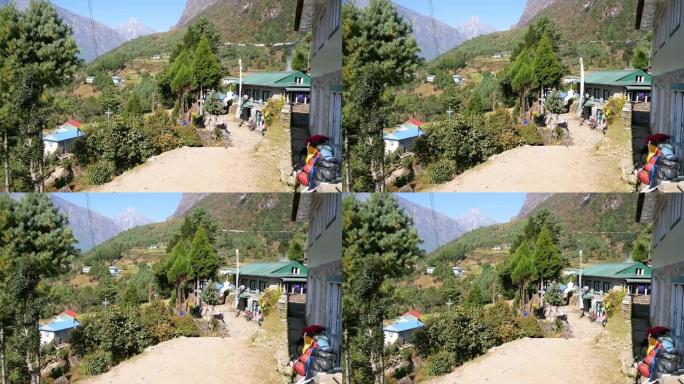 在Dudhkoshi山谷上方的喜马拉雅山脉中，尼泊尔卢克拉附近的夏尔巴人村的景色，阳光明媚的日子里，