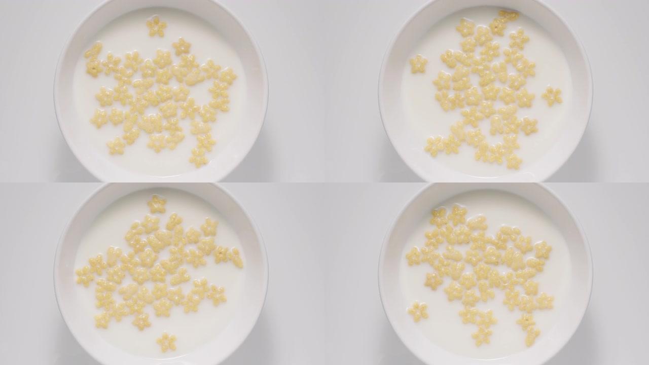 白色碗中的牛奶中的儿童玉米片，顶视图
